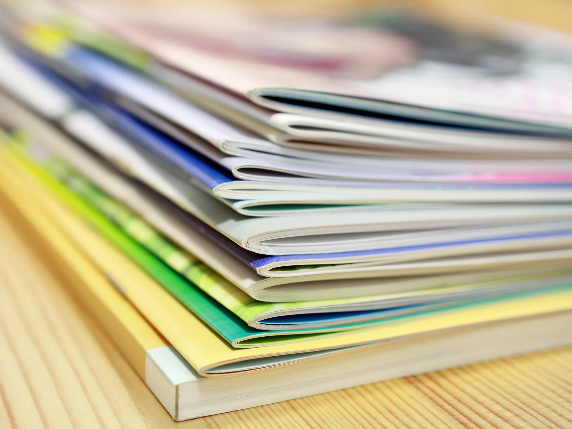 Stack of printed magazines and catalogs from press production