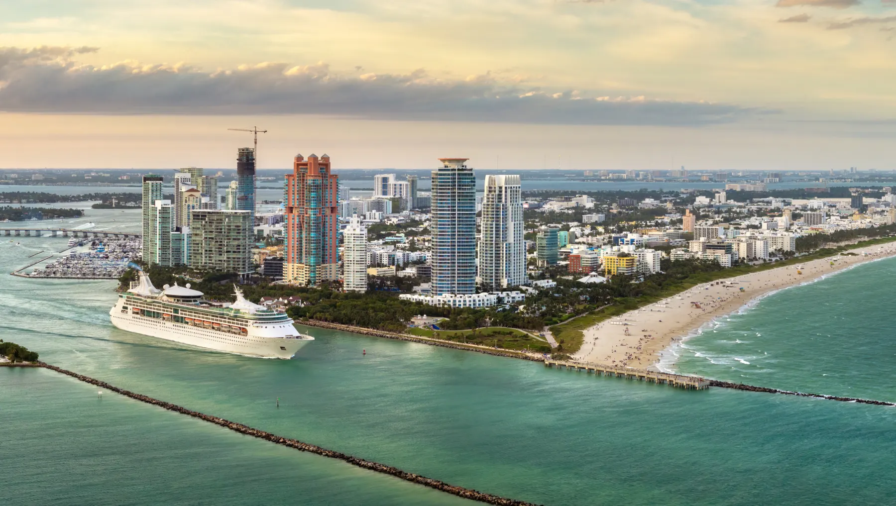 Aerial view of a cruise ship departing Miami with the city skyline in the background